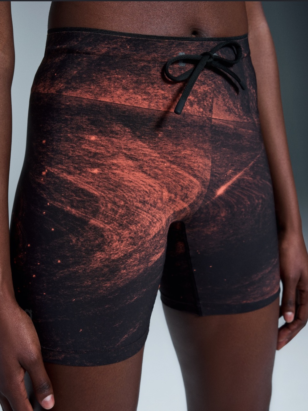 On Running Women’s Shorts in Black with Rust Orange Print